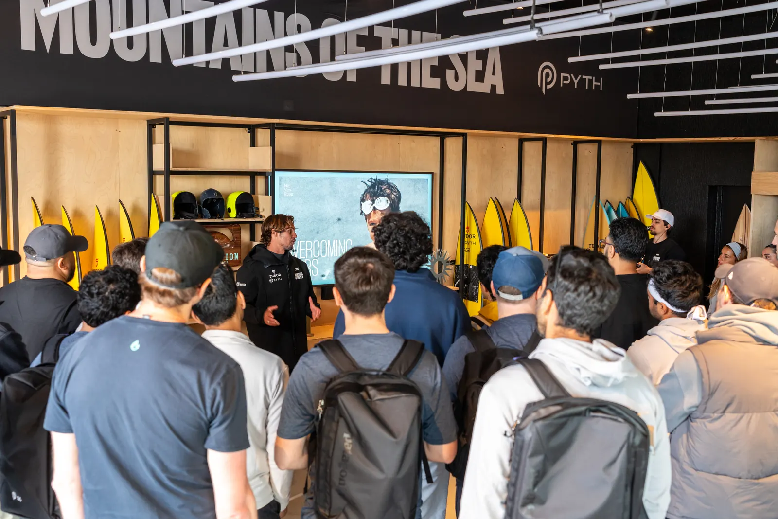 Guests listening to a Mountains of the Sea briefing inside the warehouse.