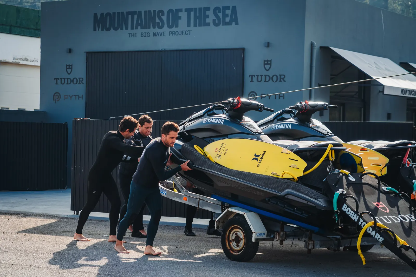 The Mountains of the Sea team moving jet skis outside the warehouse.
